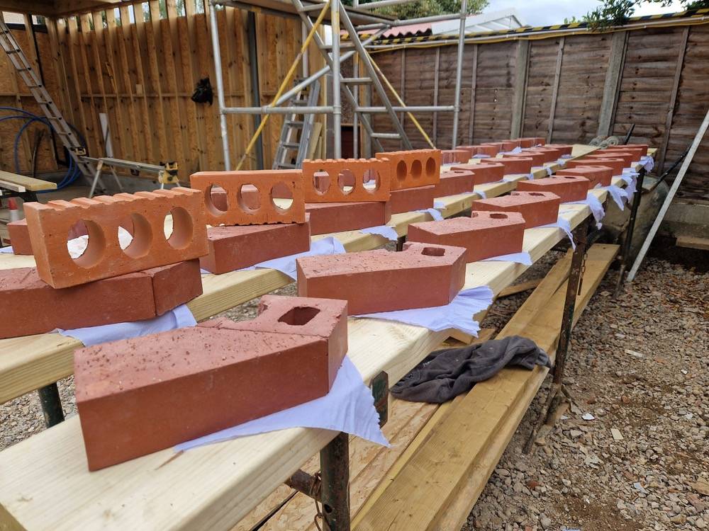 Bricks laid out ready for masonry work on extension site by DR Construction