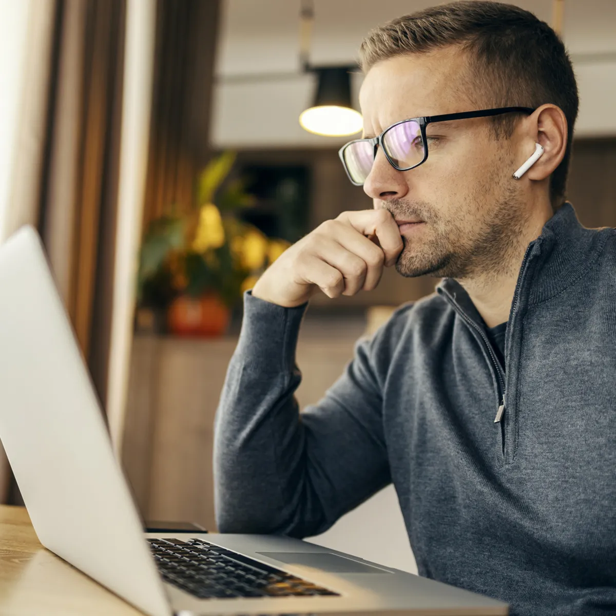 Focused executive coaching client on a virtual Ryder Method strategy session using a laptop