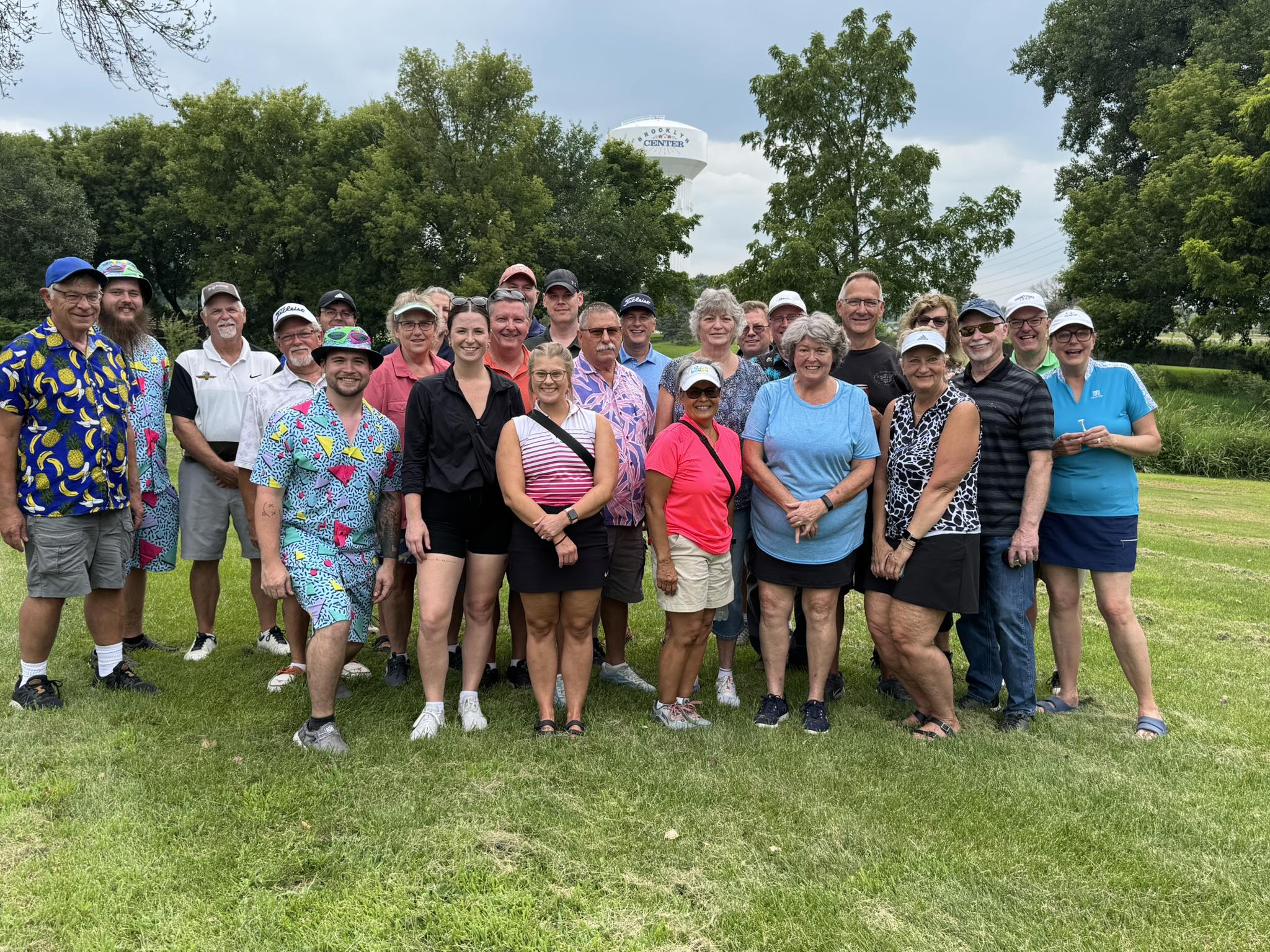 Group of people at a golf tournament supporting the community.