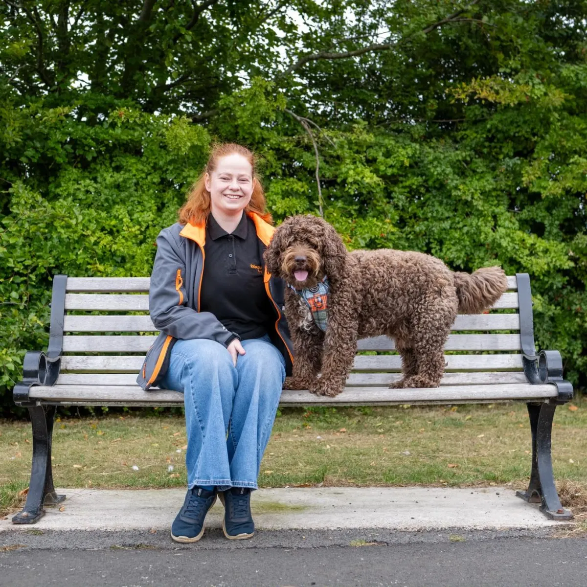 Rebecca the dog trainer siting with her dog