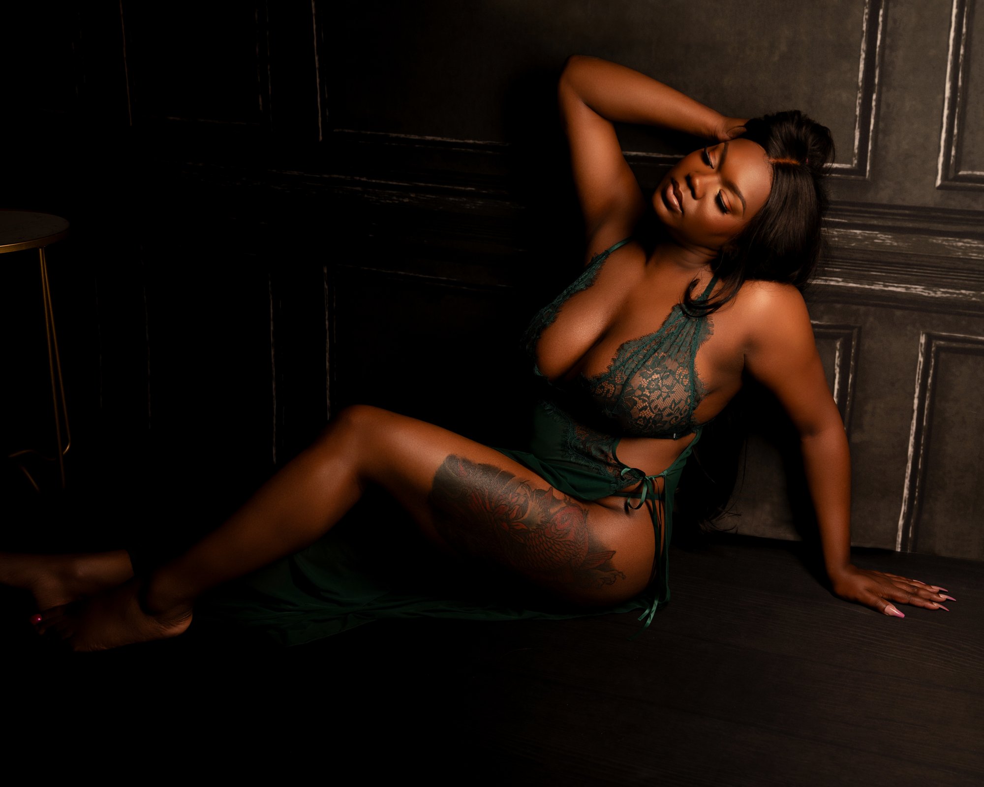 Woman reclining on chaise lounge during boudoir session