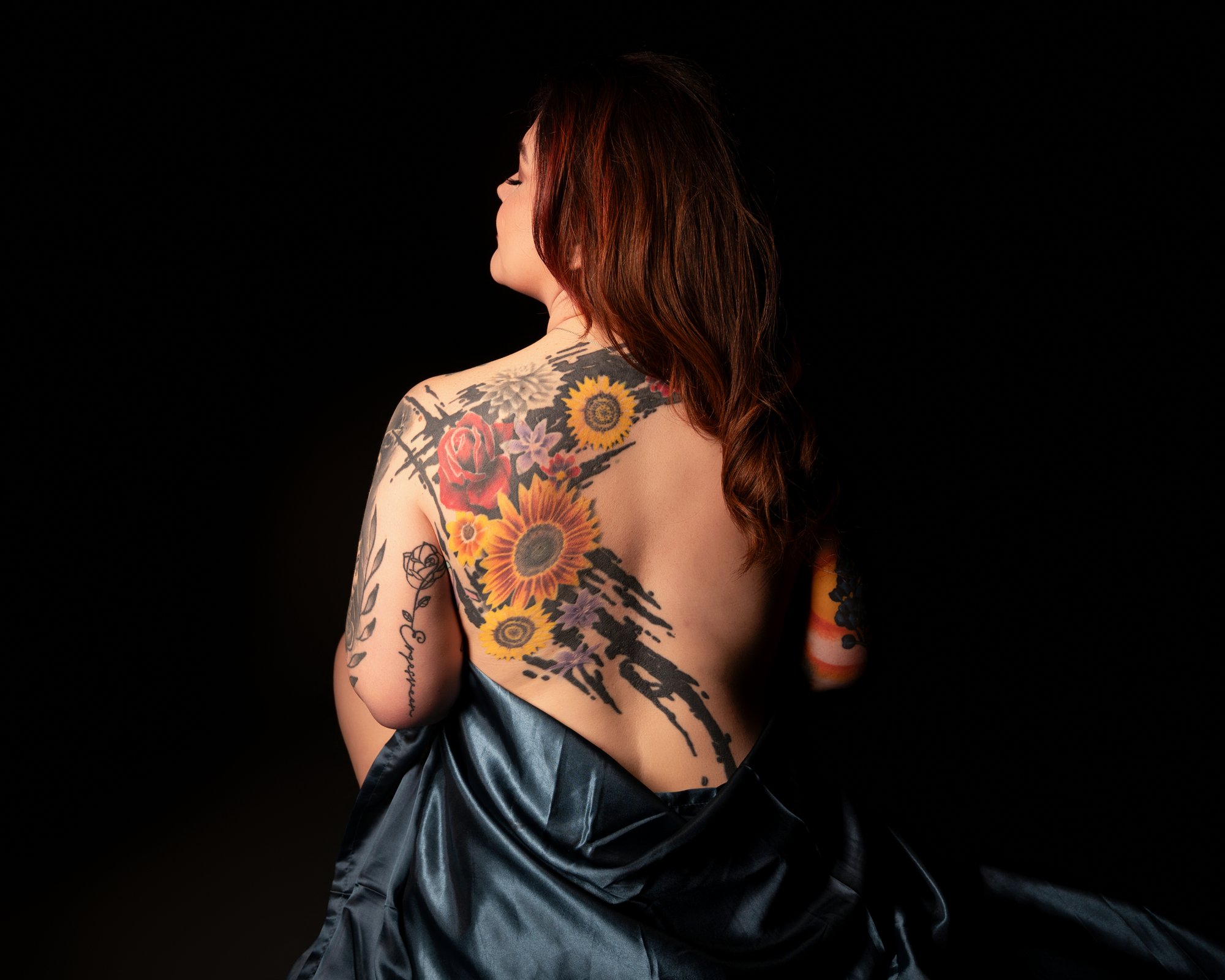 Luxury boudoir session with sophisticated aesthetic and back tattoos