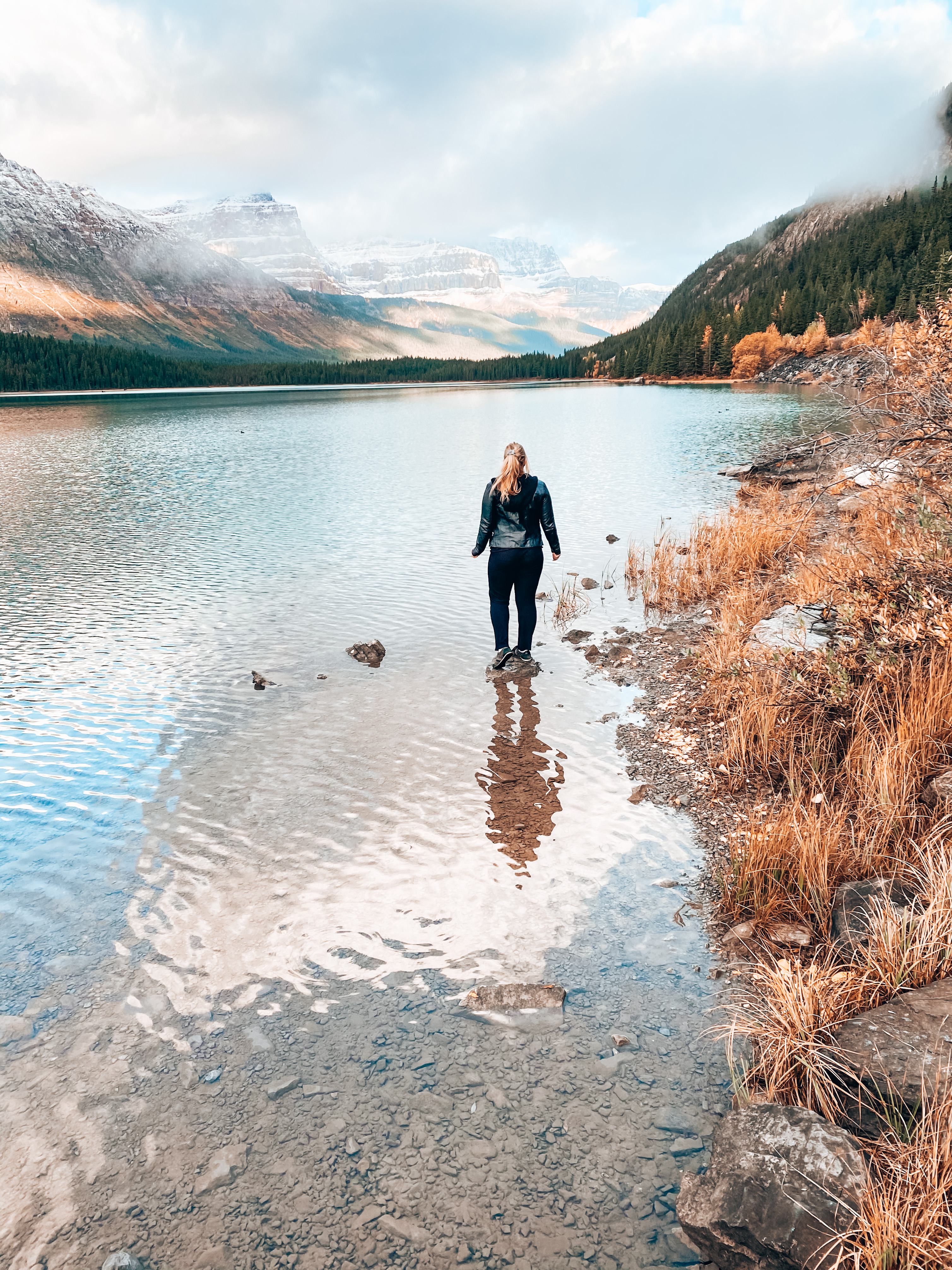 Samantha Peddle standing in the middle of the Canadian Rocky Mountains
