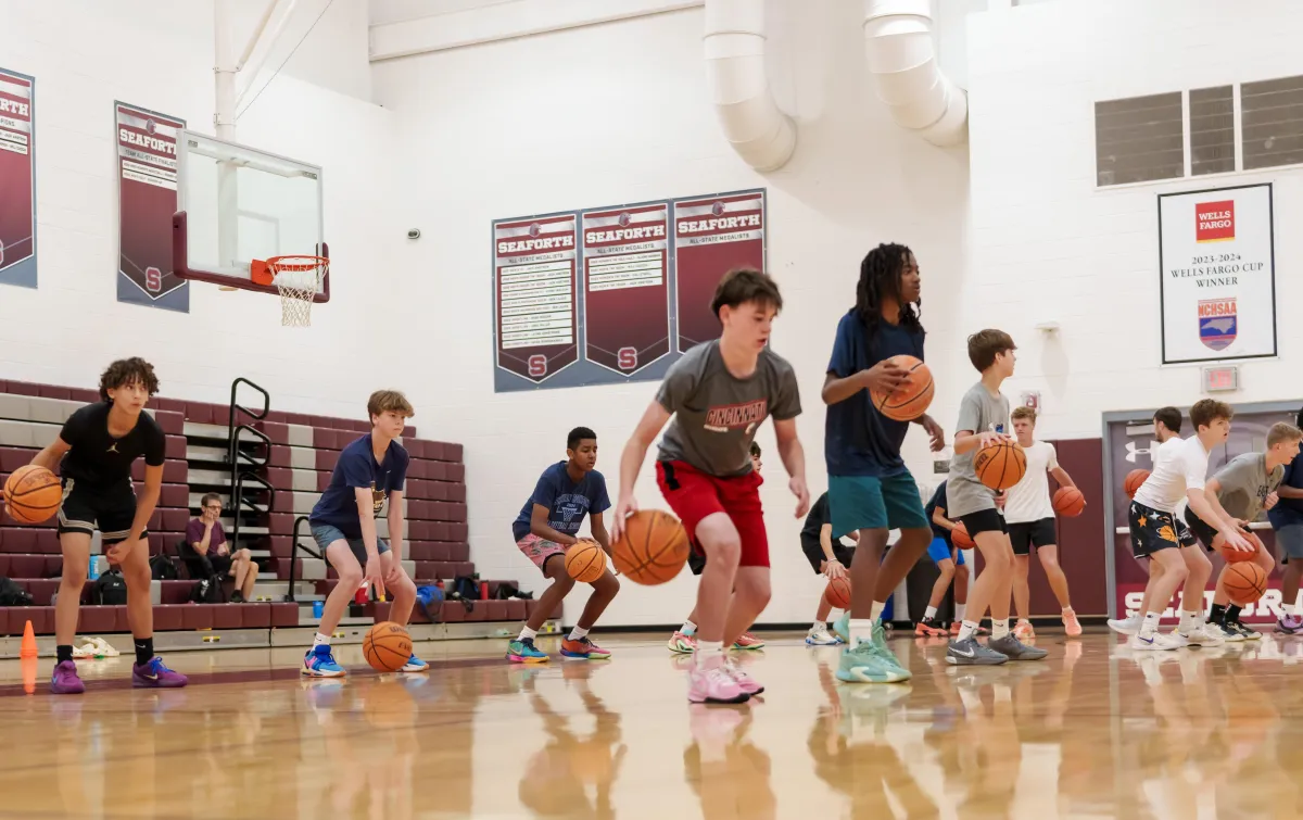 a group of young men playing a game of basketball