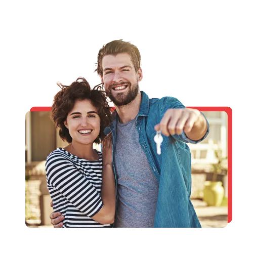 A happy couple holding keys to their new home.