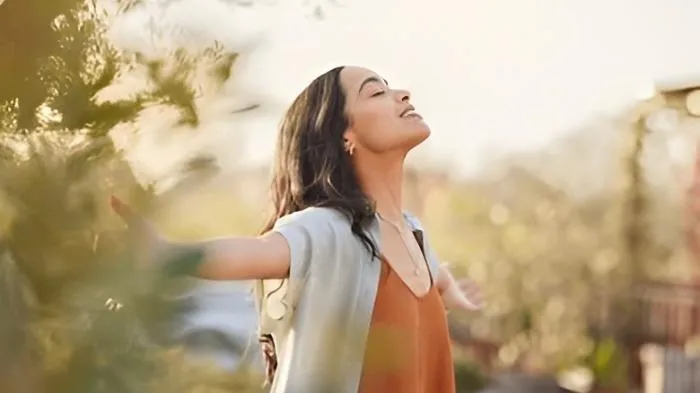 A woman feeling happy after divorce recovery.