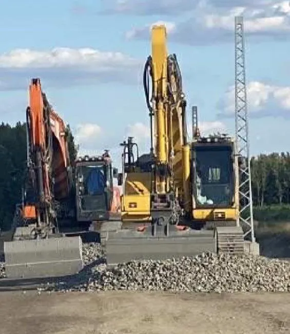 a wooden walkway leading to a building with glass doors