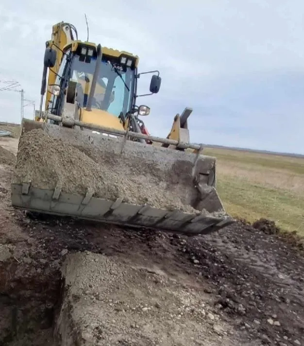 a wooden walkway leading to a building with glass doors