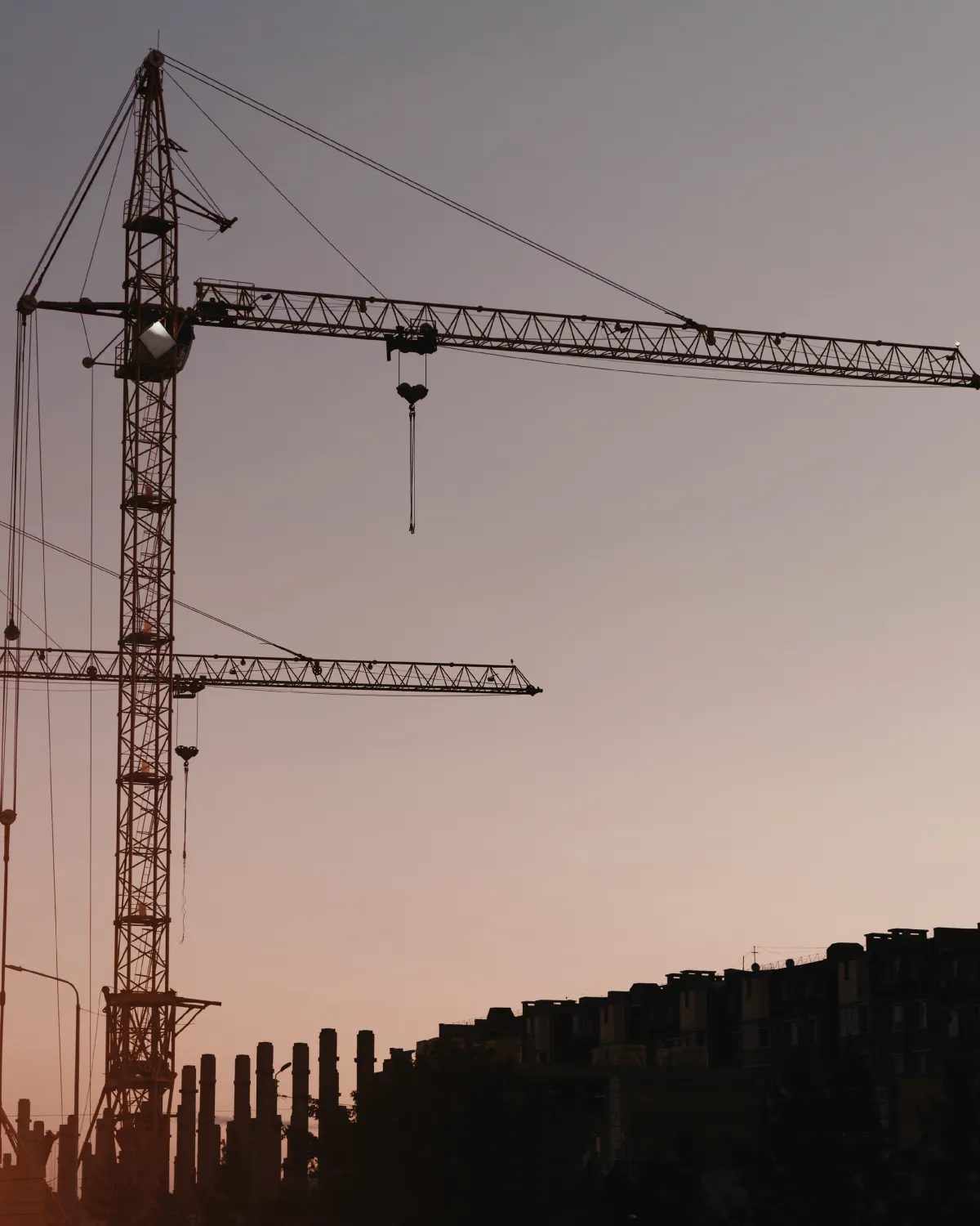 a wooden walkway leading to a building with glass doors