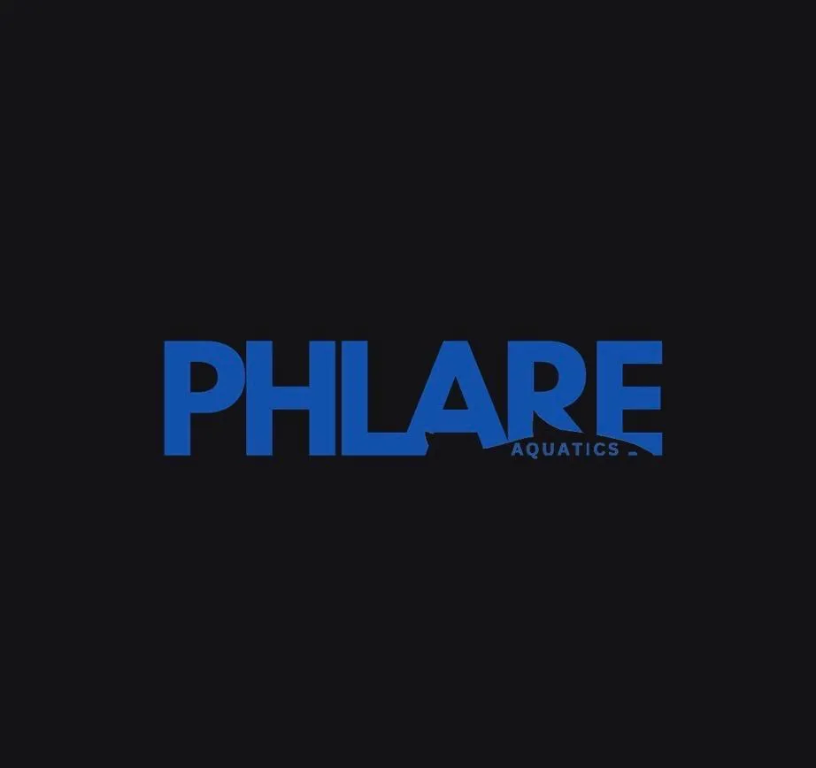 a body of water surrounded by rocks and grass