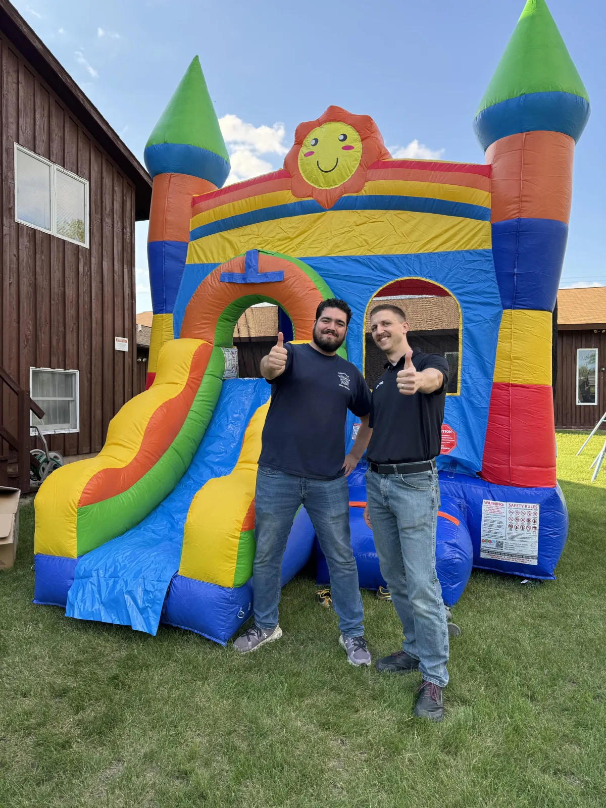 A cinematic backyard scene of a vibrant bouncy house with happy kids