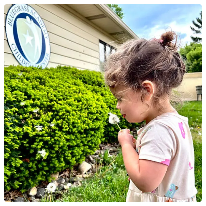 Child playing outdoors at Blue Grass Academy