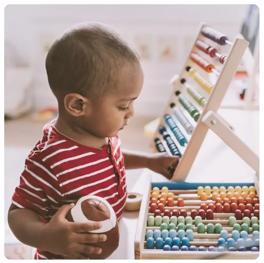toddler exploring counting at bluegrass academy