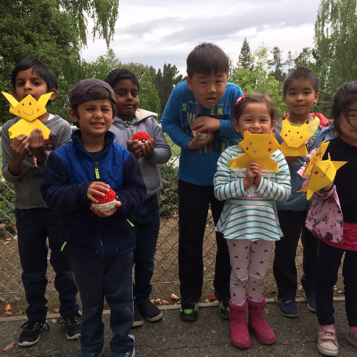 Campers proudly holding up crafts they made