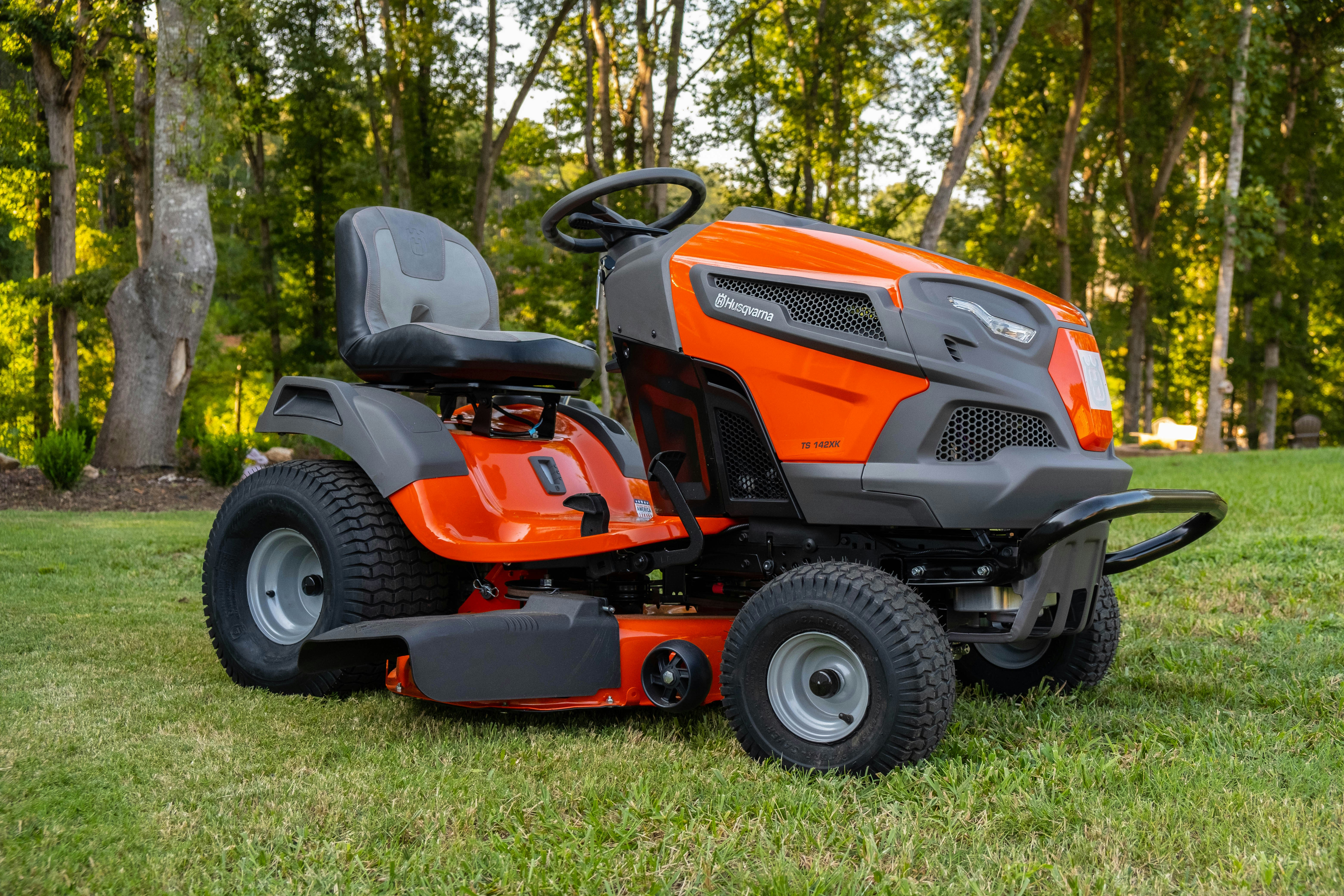 orange lawn mowing vehicle facing right