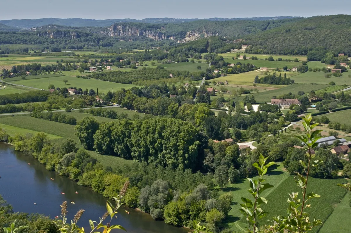 Aerial view of the Sunder River Valley showing the river on the lefthand side and reen farmland spreading off into the distance divided by groves of trees and dotted with farmhouses