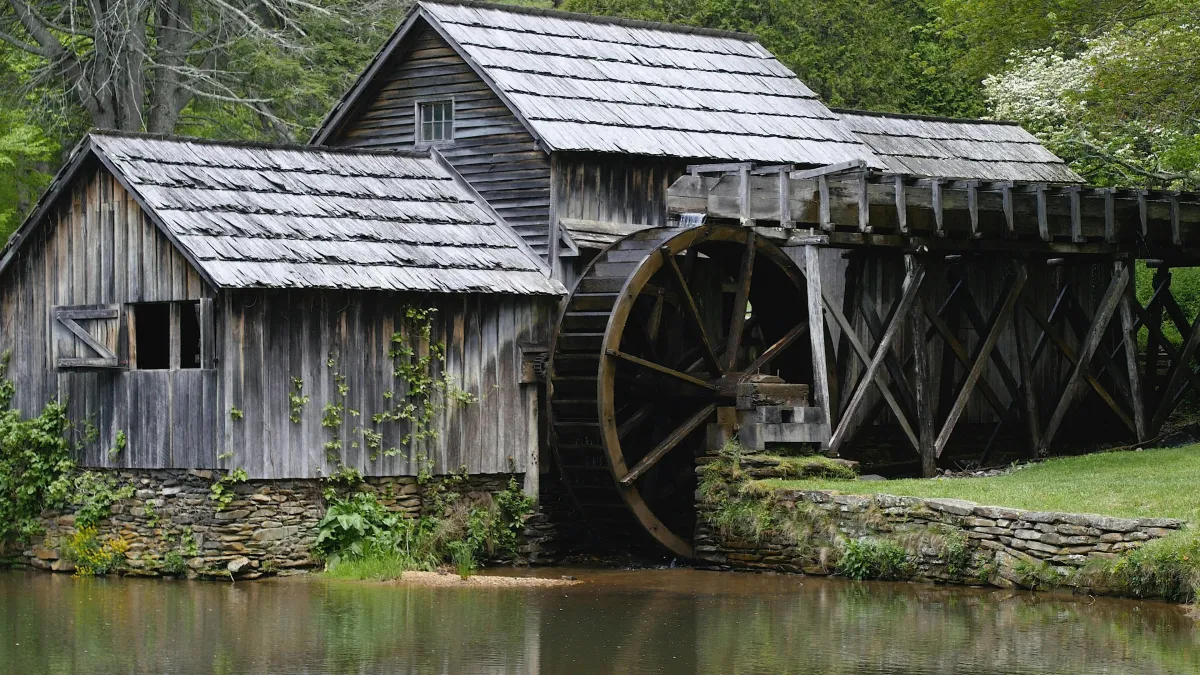Elydia's mill on the Sunder River made of sun-weathered and graying boards, a few vines of ivy climbing the walls, and hints of greenery all around