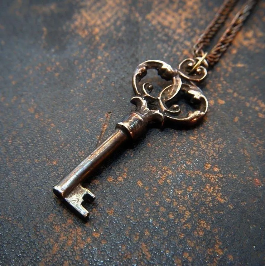 Skeleton key with ornate handle attached to a leather cord