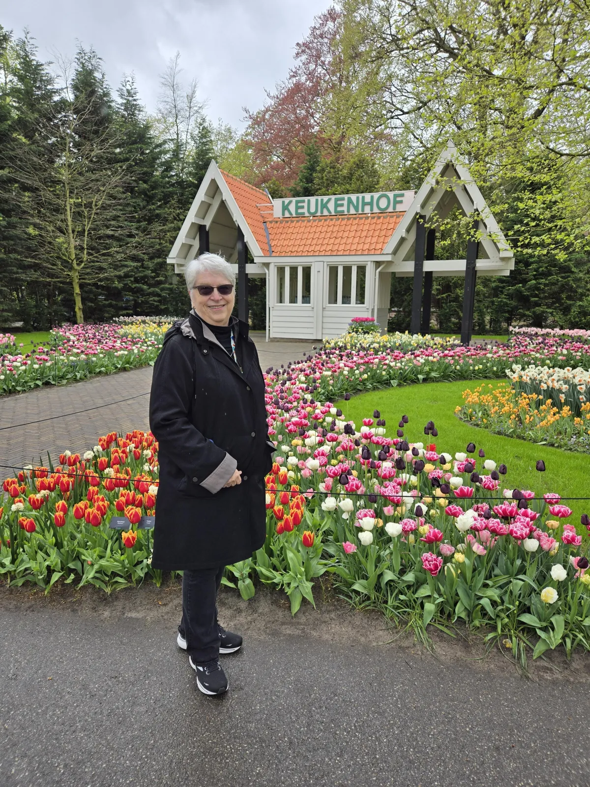 C. S. Fitzpatrick standing before an array of brilliant tulips at Keukenhof in the Netherlands