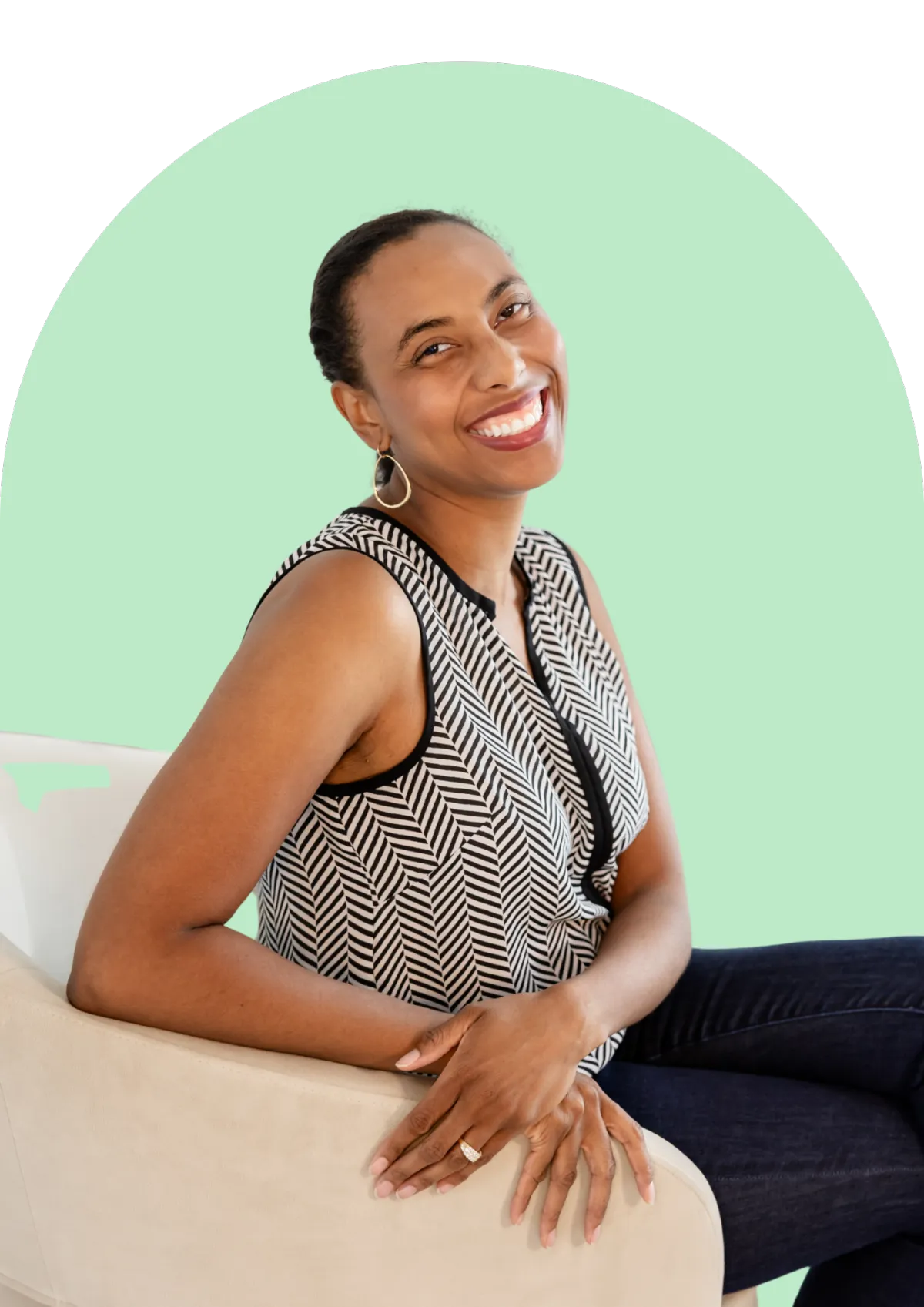 Meisha, relationship coach, smiling while seated, representing warmth and support