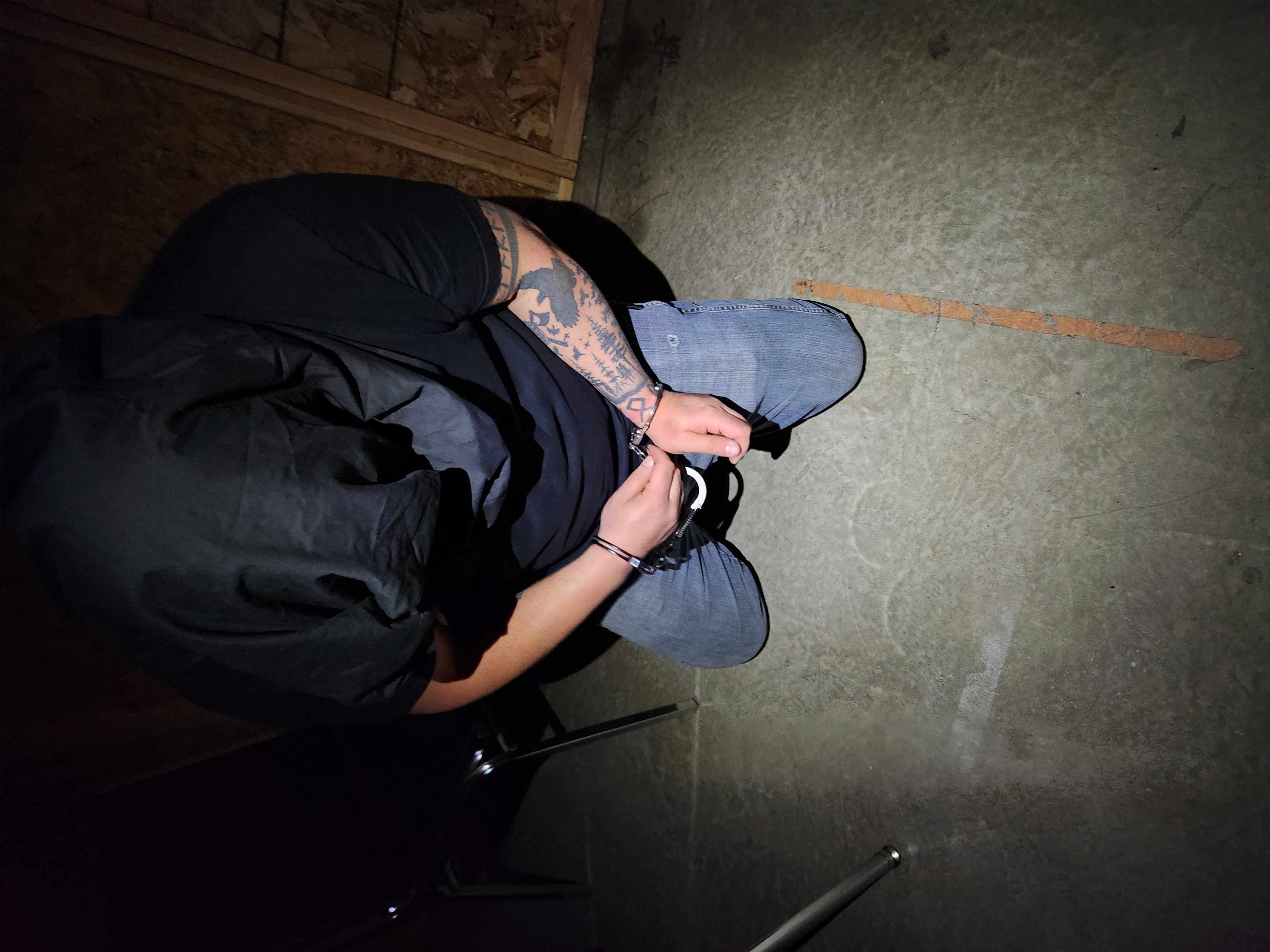 Tactical gloves and a discreet escape tool on a matte black surface