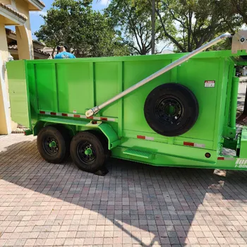 Dump trailer rental parked at a residential home in South Florida for garage cleanout or yard waste