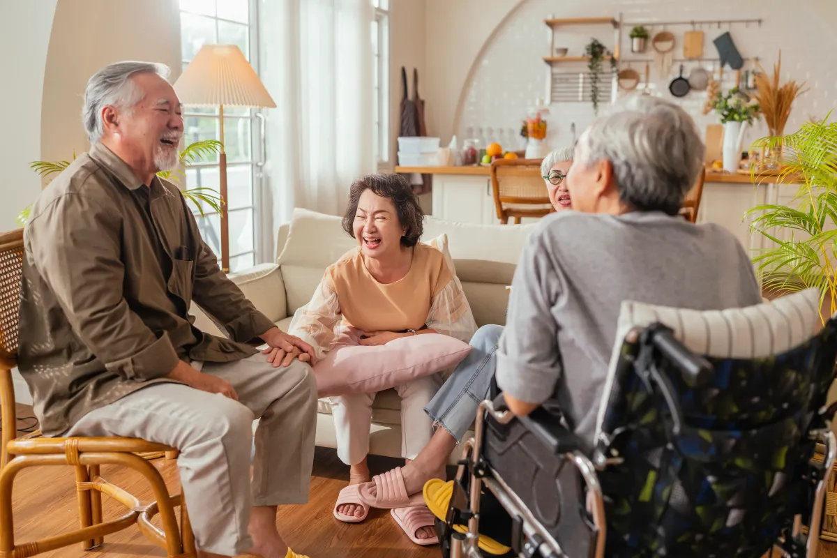 old people laughing together while in assisted living facility