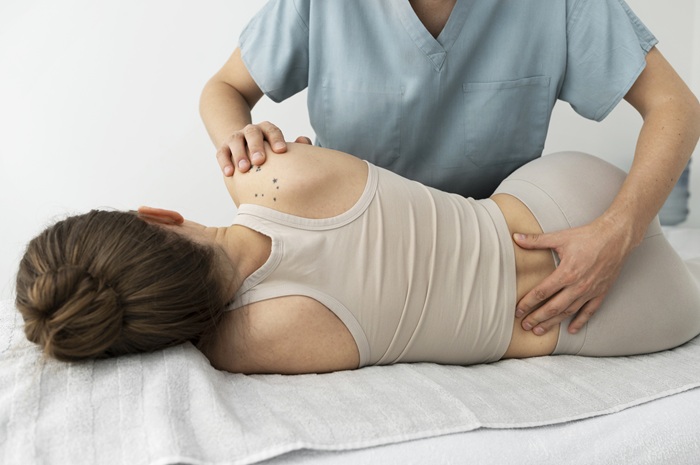 Chiropractor Doing adjustments For Female Patient