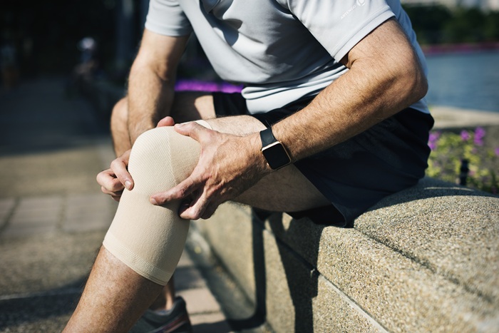 Sport Mid Age Man with Knee Pain while running