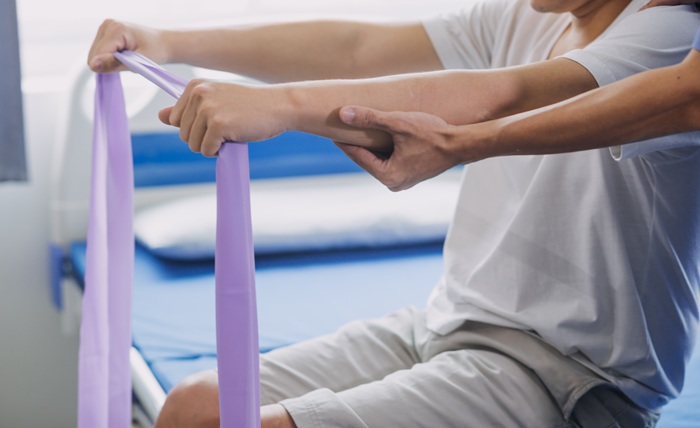 Patient Doing Rehabilitation Therapy Exercise in Tucson Clinic