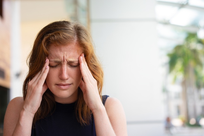 Young professional women feeing dizzy at work