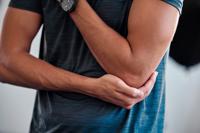Young Sport Man with Elbow Injury