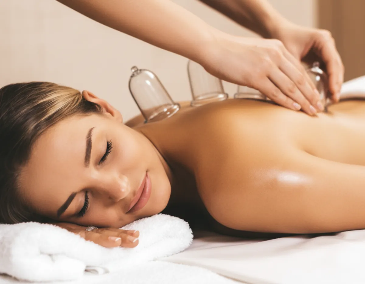 Cupping therapy session showing silicone or glass cups applied to the back.