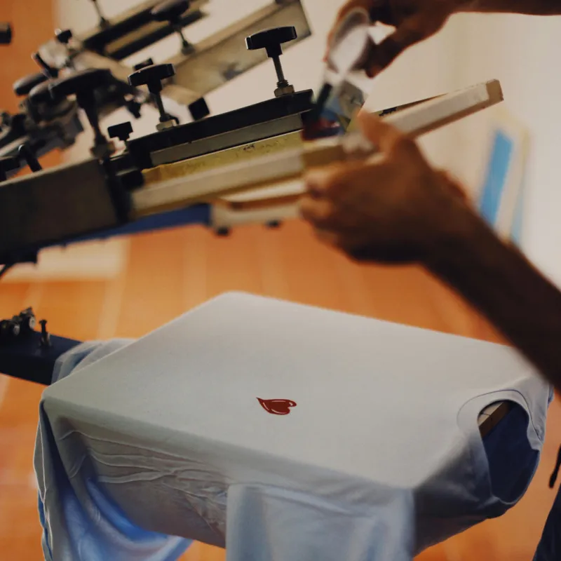 Screen printing process for custom apparel and embroidery orders.