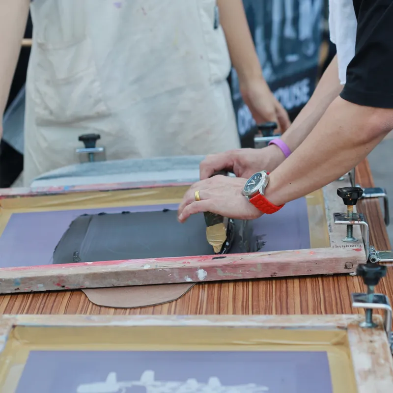Custom apparel screen printing process with ink and screen for Gunnison Valley orders.