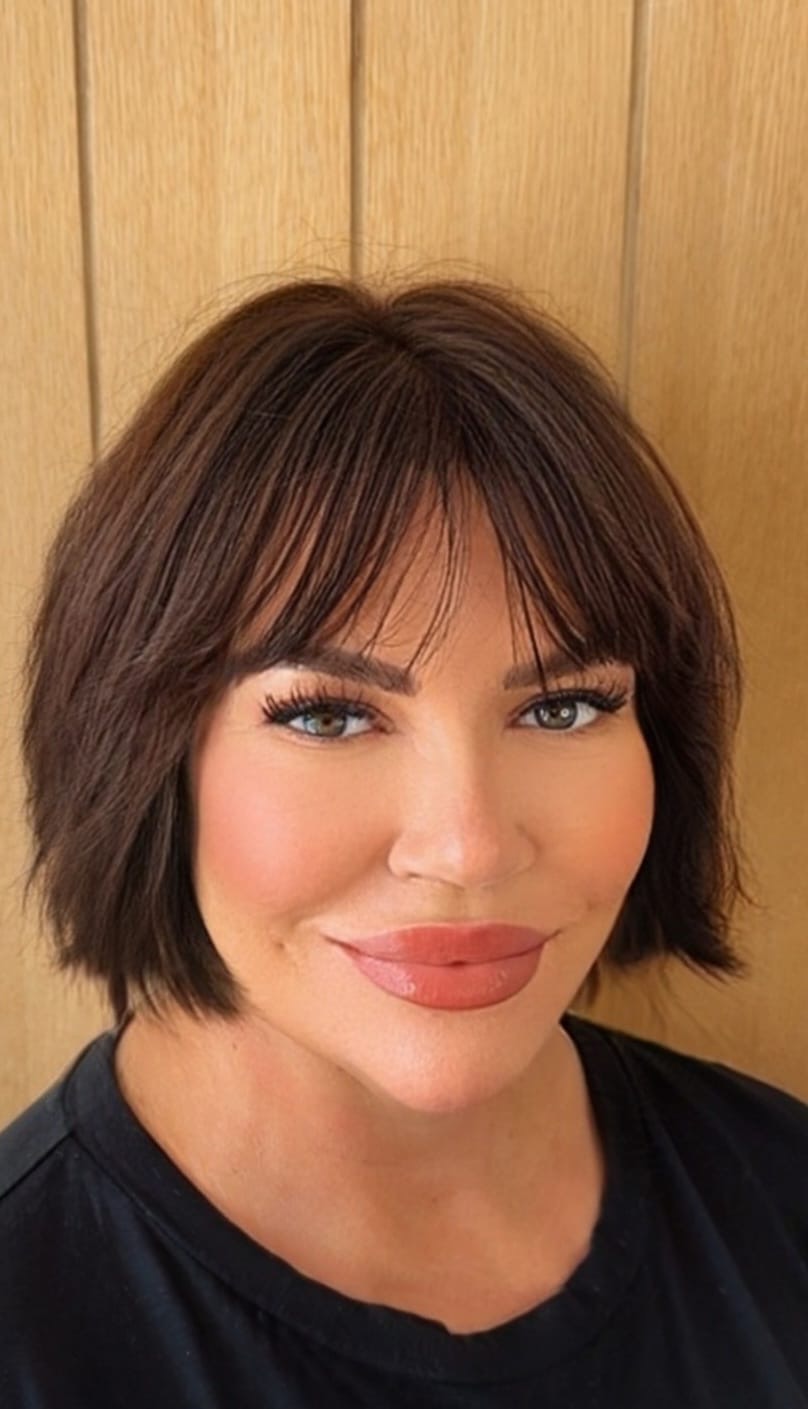 Woman with an injection needle pointing towards her eye smile wrinkles
