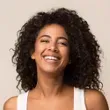 a woman with curly hair smiling 