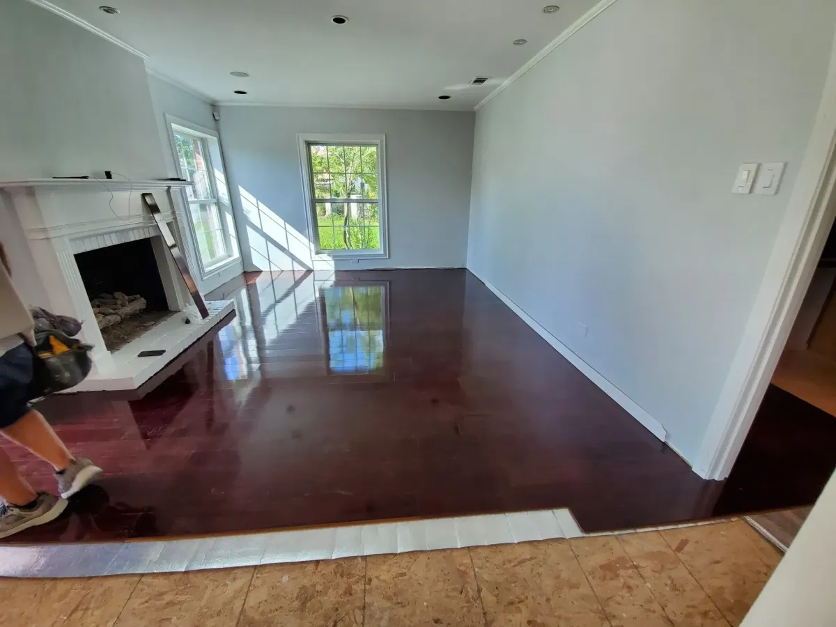 a person in a room with a fireplace and a mirror