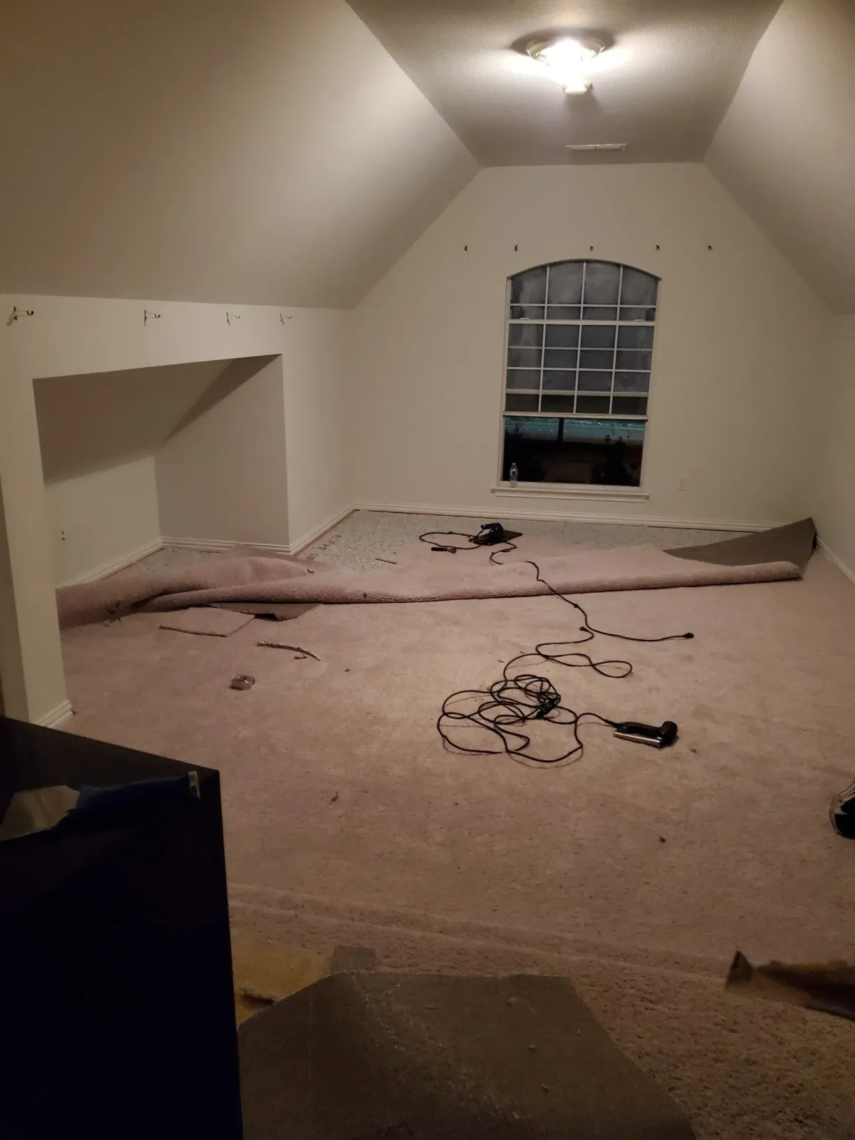 an empty room with a lot of wires on the floor