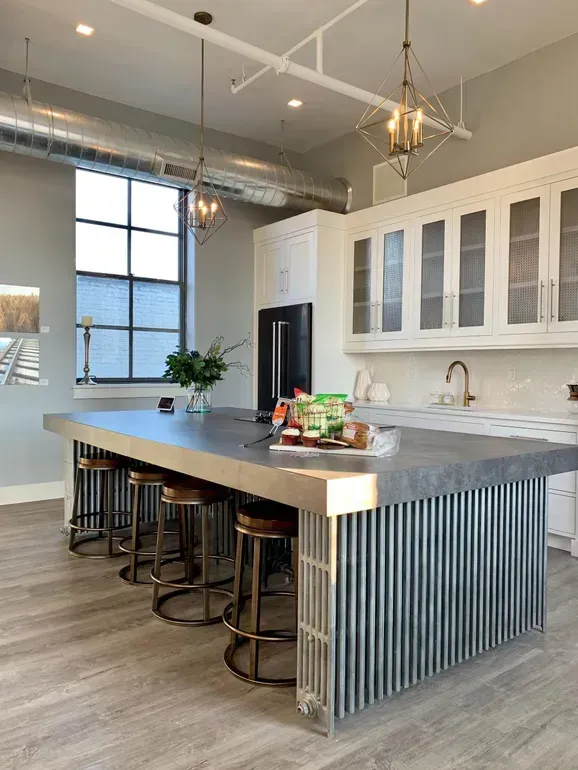 a large kitchen with a center island and bar stools