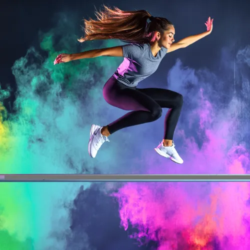 woman jumping over an obstale