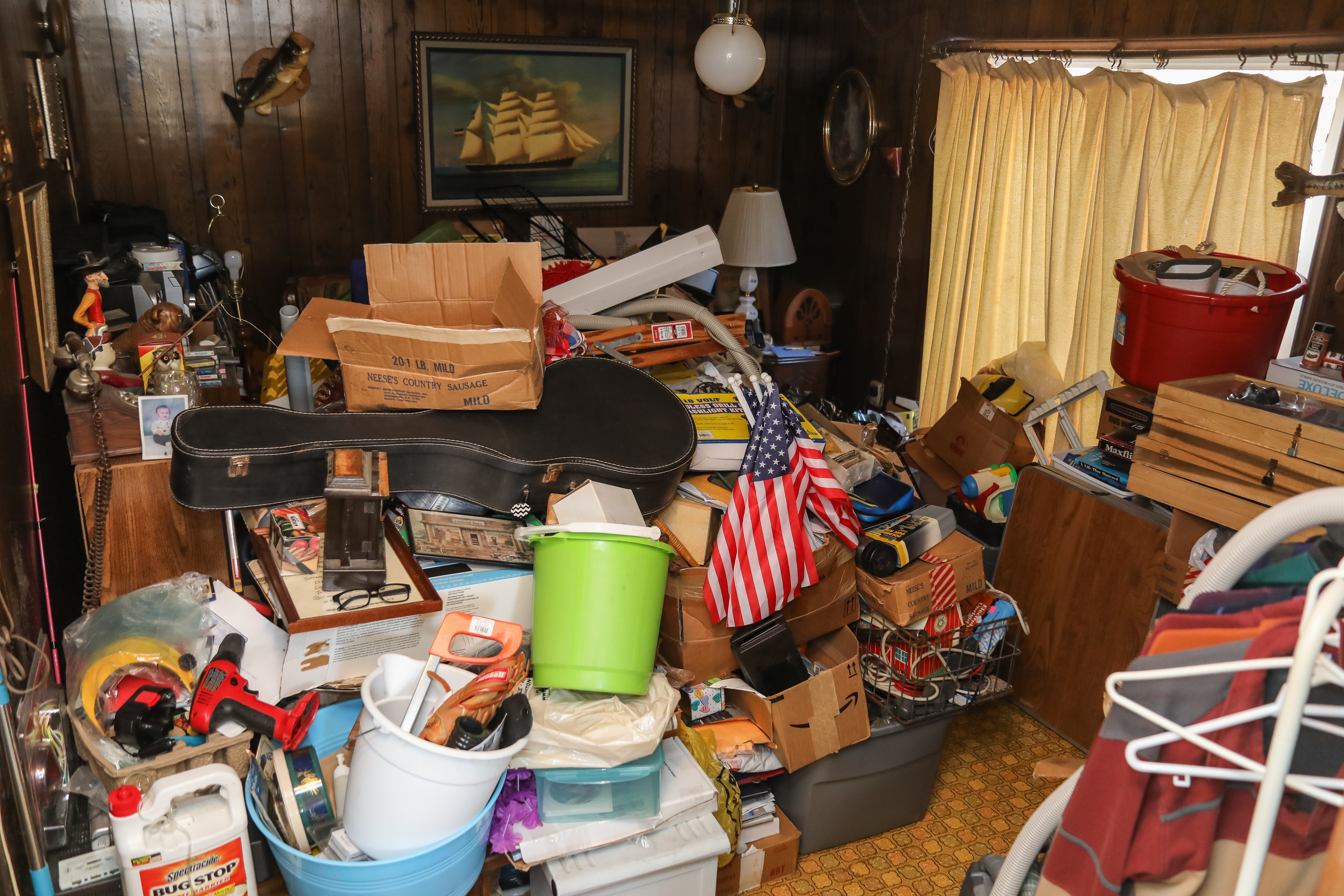 Overwhelming cluttered room in Charlotte NC before an estate cleanout and whole-home junk removal service.