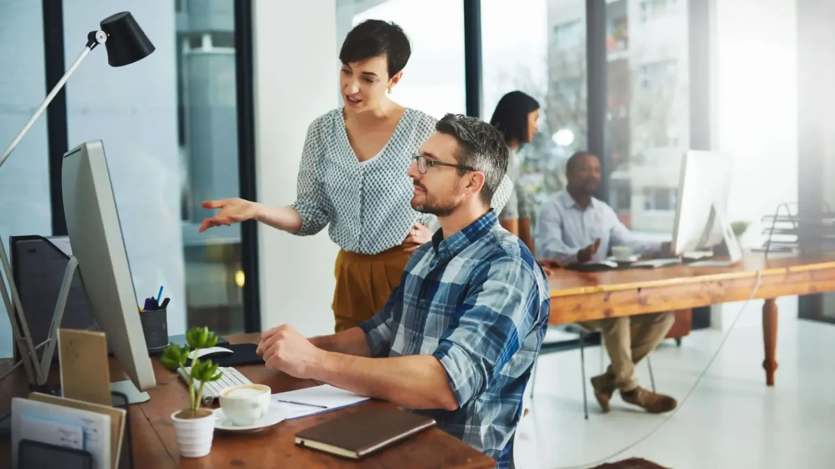 Three-image collage showing a smiling woman reviewing documents, a consultant pointing at a tablet, and hands organizing charts in a modern office.