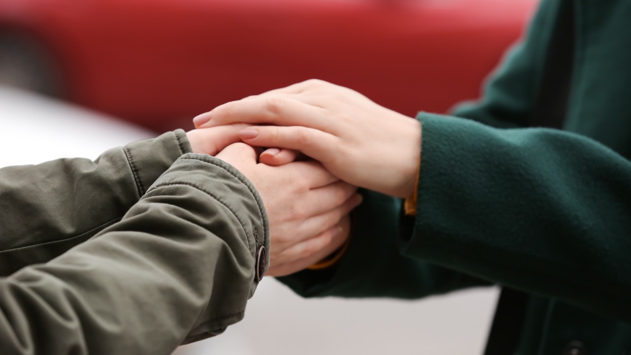 Hand grasping another hand as a form of empathizing