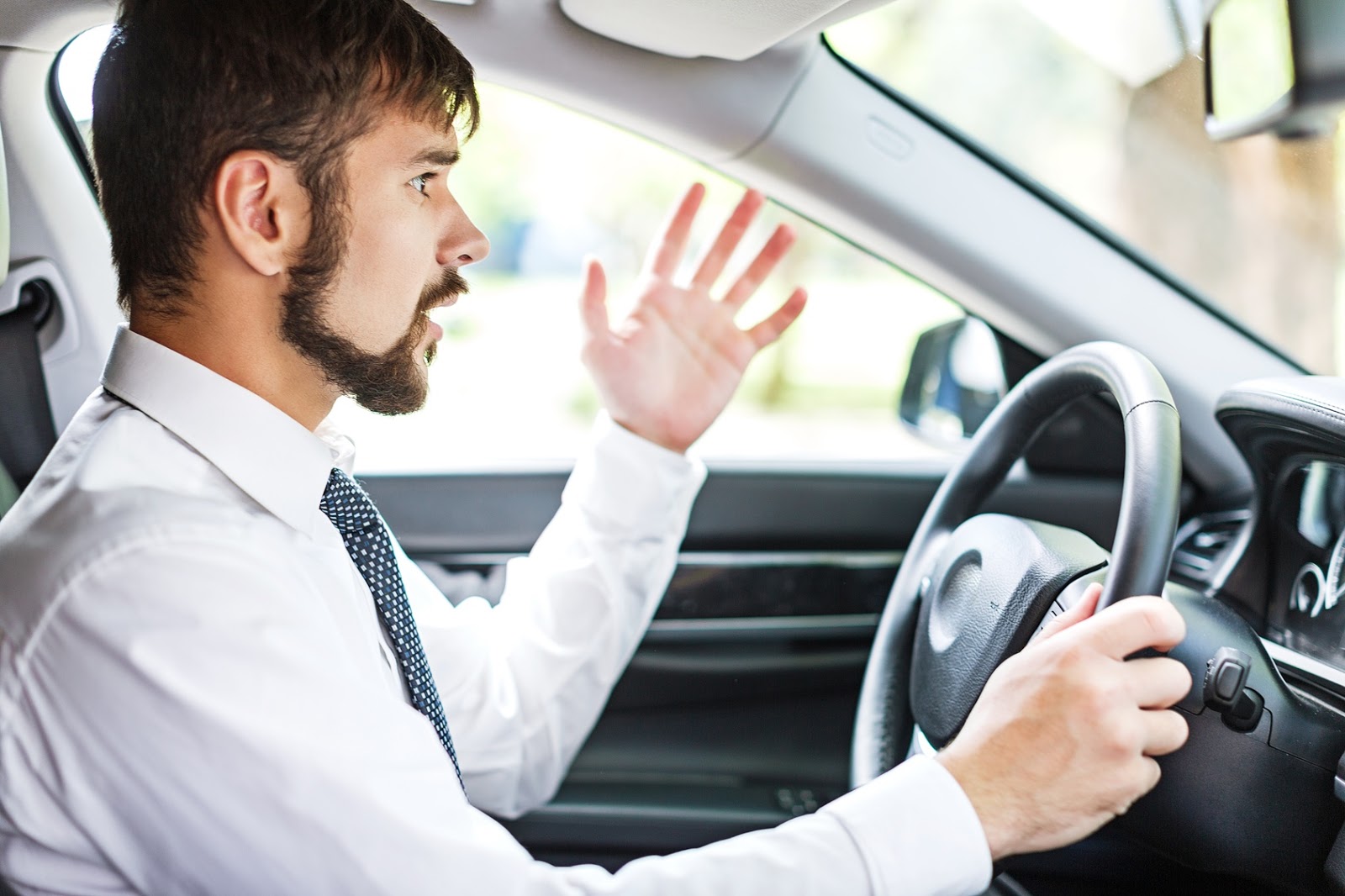 Hands on a steering wheel as an unexpected turn appears ahead on the road