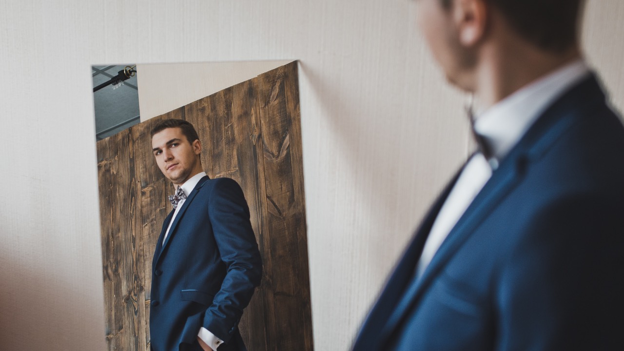 Man looking at his reflection