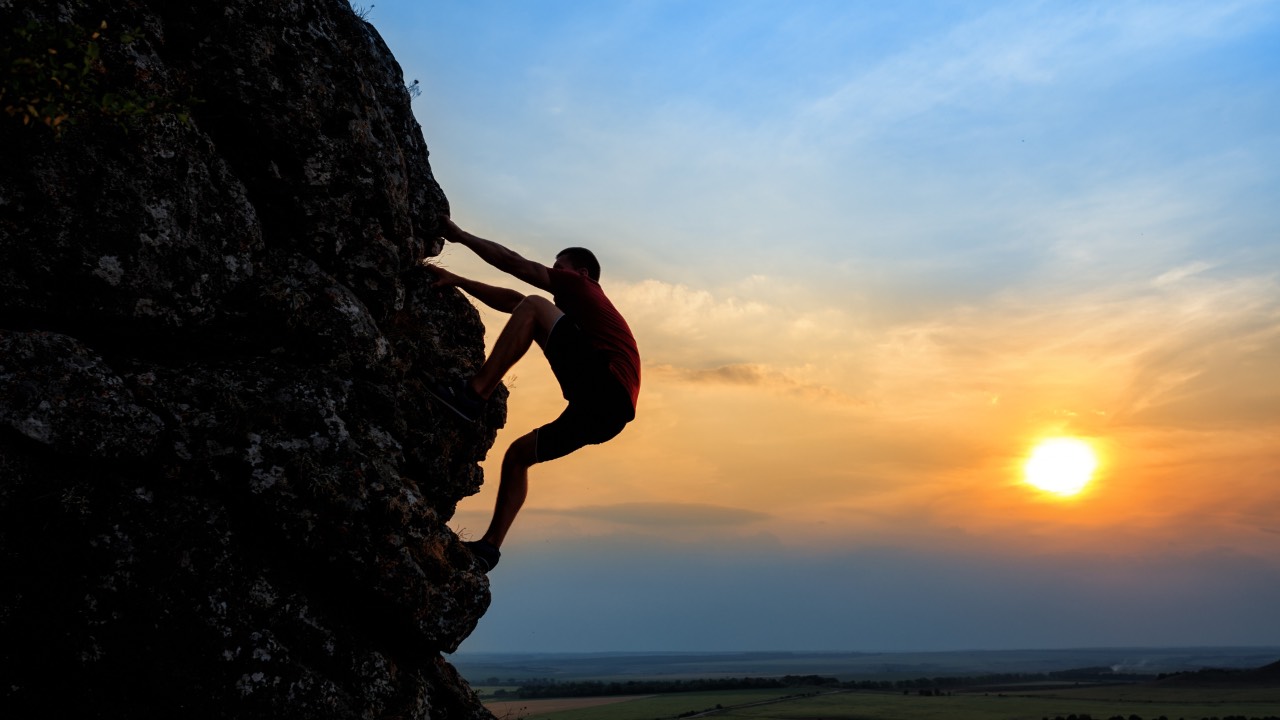 person climbing a mountain