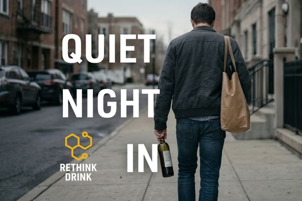 man walking home after work carrying a bottle of wine down the street