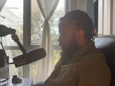 Anthony Wednesday speaking into a studio microphone, representing the personalized one-on-one coaching inside the GovCareer Accelerator program