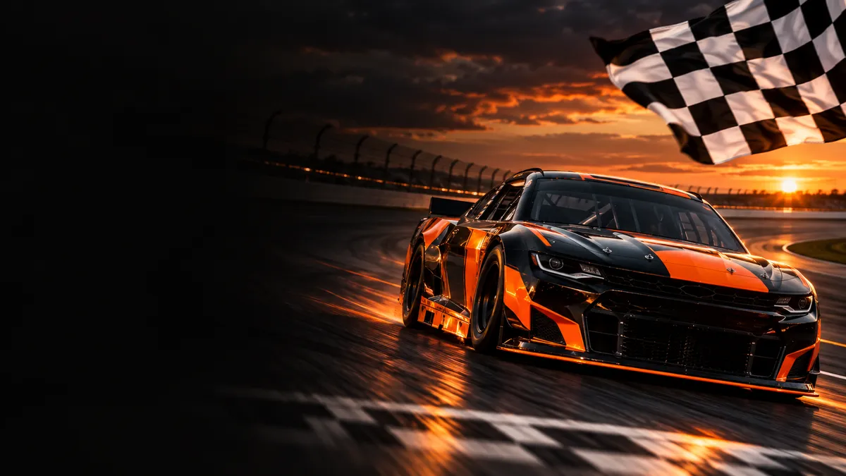 Black and orange stock car racing toward a checkered finish line
